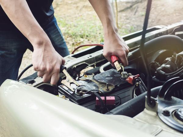 mechanic fixing a car battery