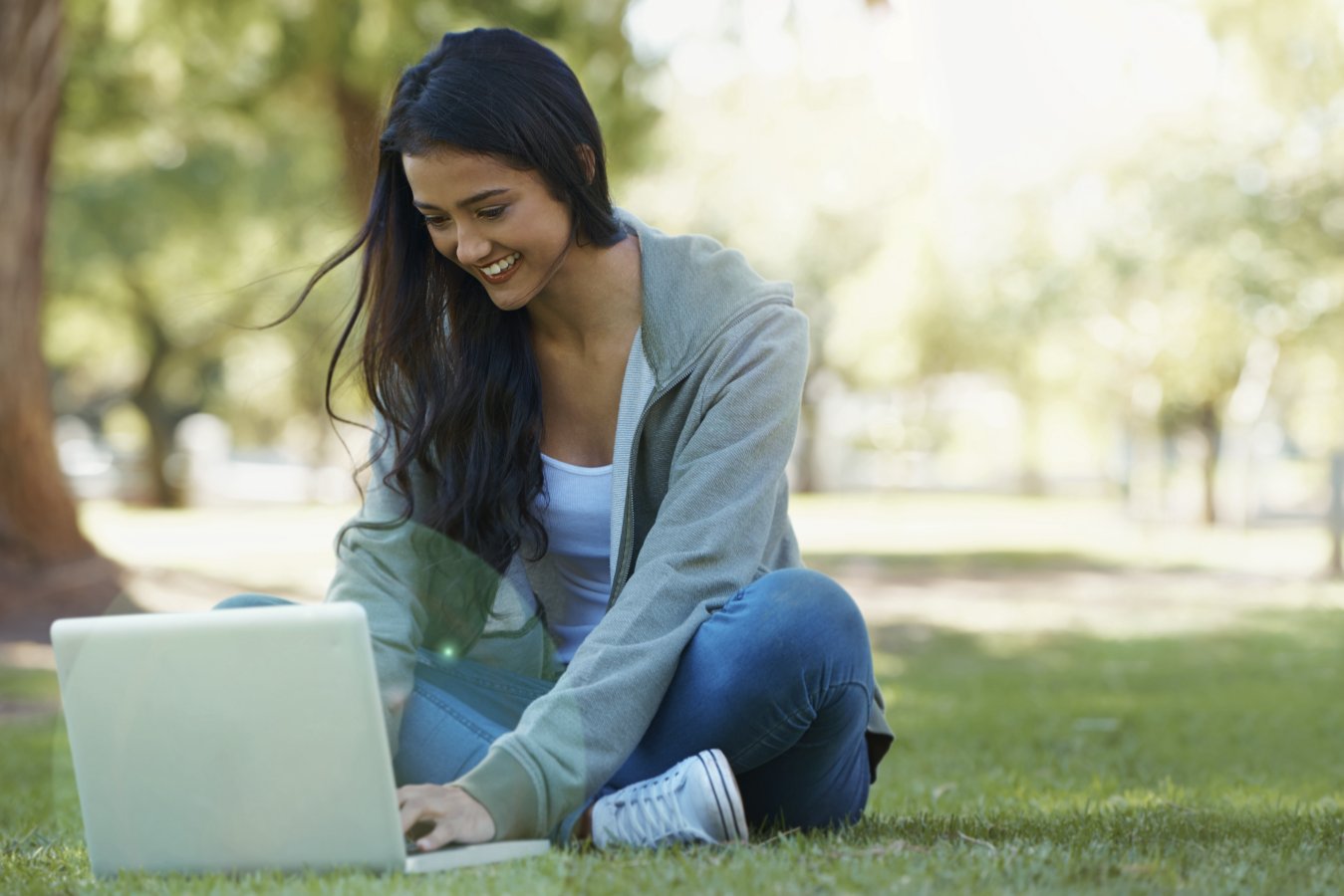 woman sitting in park with computer